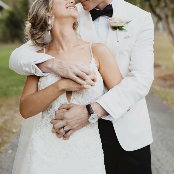 Photo of happy couple on wedding day wearing tungsten wedding ring from The Gentleman's Smith