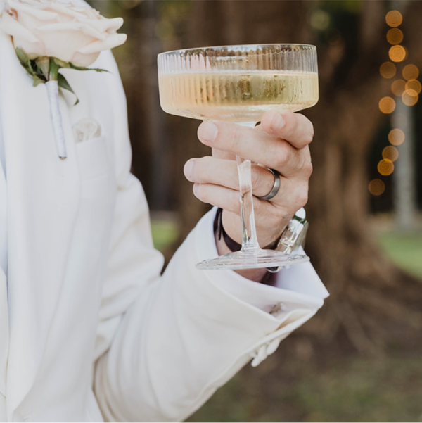 Man toasting at his wedding while wearing his Tungsten wedding ring.