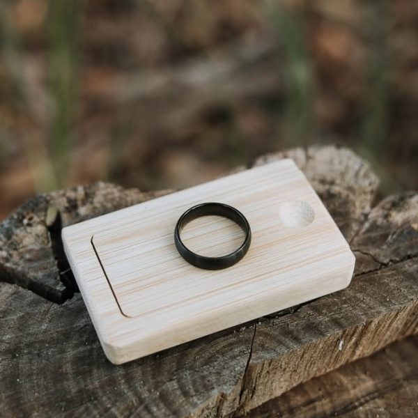 Black wedding ring on wooden box